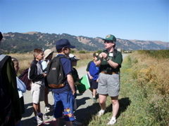 Ranger Cheryl points out plant growth